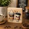 Coffee Cup Sweethearts Sign featuring two cute smiling coffee cups holding hands with hearts above them on a natural pine wooden desk sitter displayed in a cosy coffee bar setting.