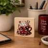 Cute Hot Chocolate Sitter wooden desk sign featuring a red polka-dot cup with whipped cream, chocolate pieces, candy-cane straws and a heart.