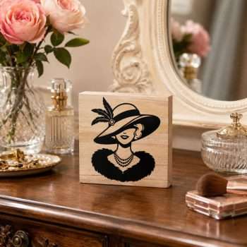 Pretty lady wearing a large feathered hat on a 4 x 4 inch wooden desk sitter with natural pine sides.