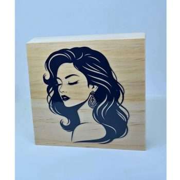 Elegant Lady Shelf Sitter featuring a black silhouette of a woman with long flowing hair on a natural wooden block displayed on a decorative shelf.