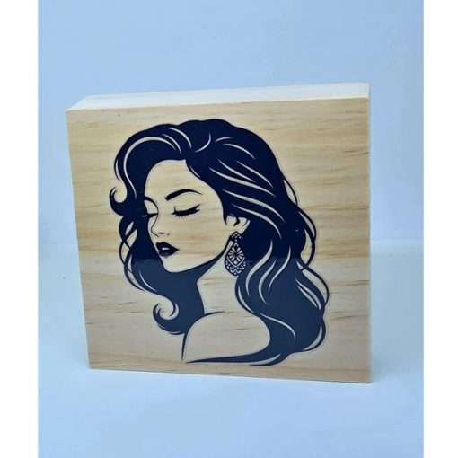 Elegant Lady Shelf Sitter featuring a black silhouette of a woman with long flowing hair on a natural wooden block displayed on a decorative shelf.