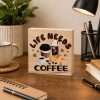 Life Needs Coffee wooden desk sitter sign featuring coffee cups, iced coffee and a croissant on a natural pine block displayed on a cosy home office desk.